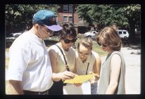 A family on campus looks at a document